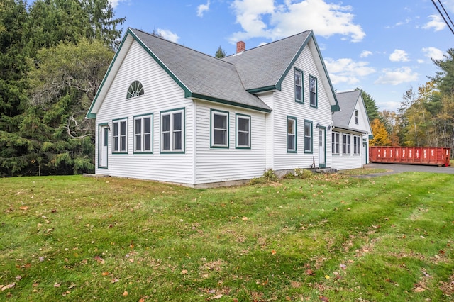 view of property exterior featuring a lawn