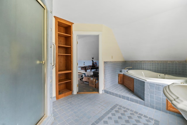 bathroom featuring tile patterned floors, vaulted ceiling, independent shower and bath, and built in features