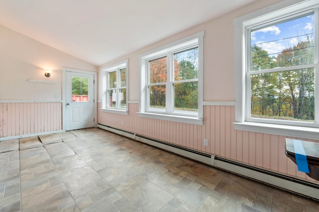 unfurnished sunroom featuring lofted ceiling, a baseboard heating unit, and plenty of natural light