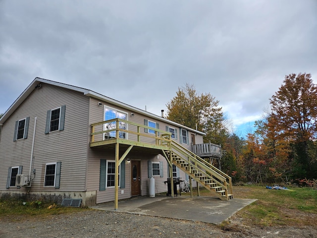 rear view of property with a patio and a deck