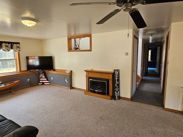 living room featuring carpet and ceiling fan