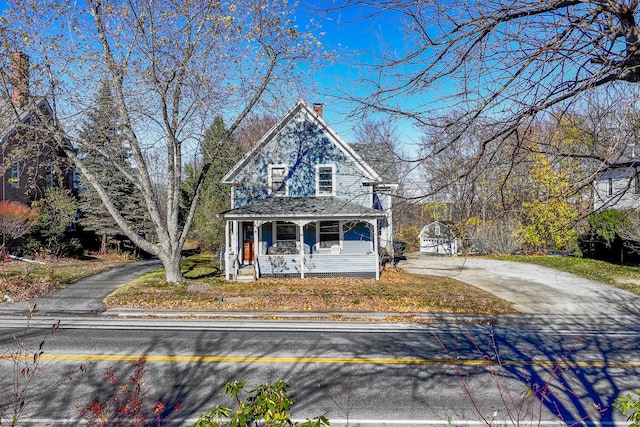 victorian home with a porch and concrete driveway