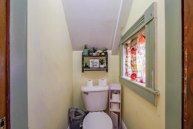 bathroom featuring vaulted ceiling and toilet