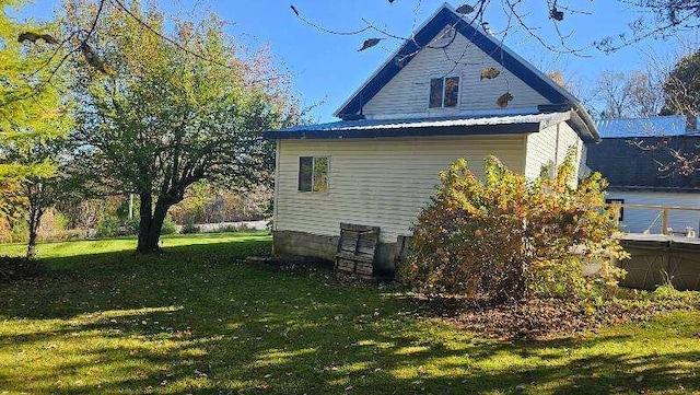 view of side of home featuring a yard