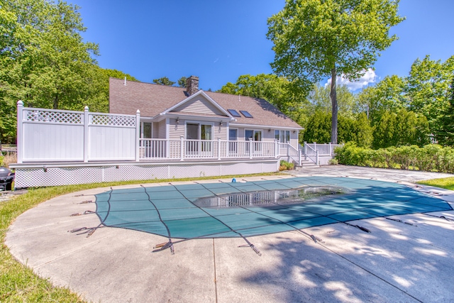 view of pool featuring a wooden deck and a patio area