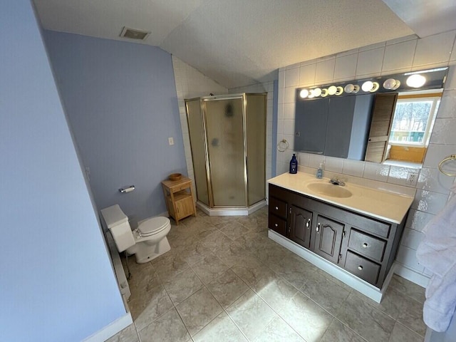 bathroom with vaulted ceiling, toilet, vanity, and a shower with shower door