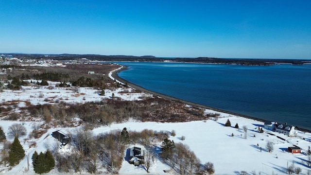 snowy aerial view with a water view