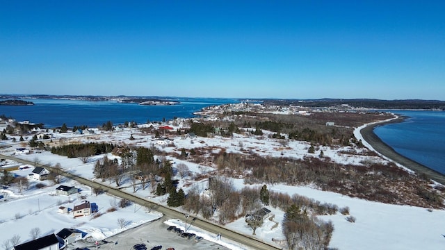 snowy aerial view with a water view