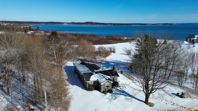 snowy aerial view with a water view