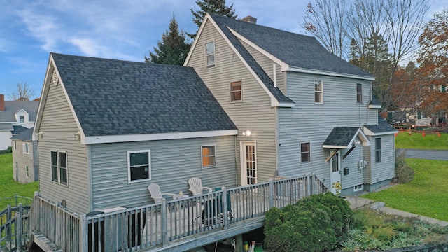 back of house featuring a yard and a wooden deck