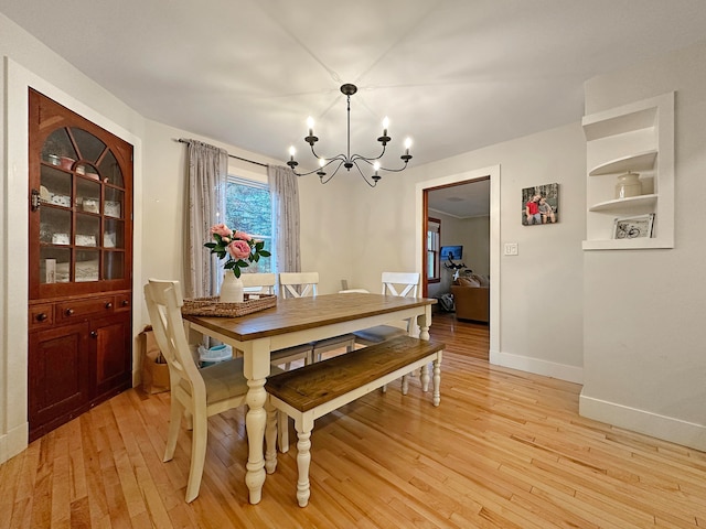 dining room featuring light hardwood / wood-style floors and an inviting chandelier