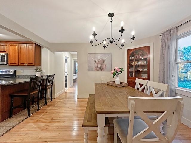 dining room featuring light hardwood / wood-style flooring and an inviting chandelier