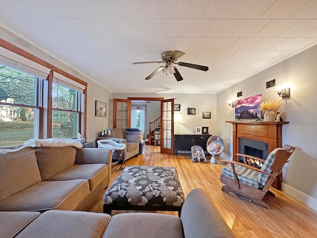 living room featuring ceiling fan, hardwood / wood-style flooring, and ornamental molding