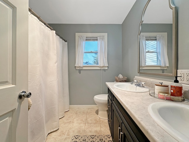 bathroom featuring toilet, walk in shower, vanity, and tile patterned floors