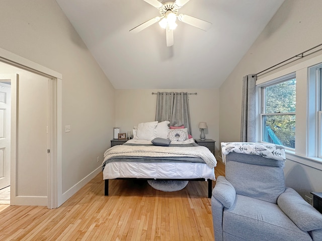 bedroom featuring light hardwood / wood-style floors, vaulted ceiling, and ceiling fan