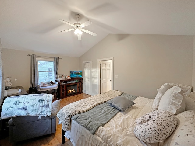 bedroom featuring lofted ceiling, hardwood / wood-style floors, and ceiling fan