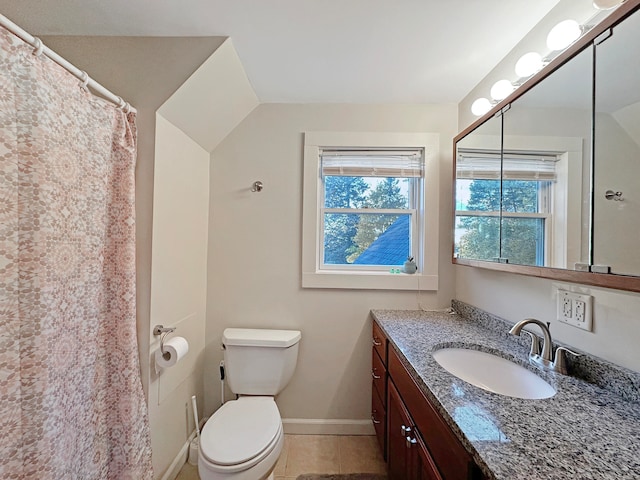 bathroom featuring toilet, vanity, and tile patterned flooring