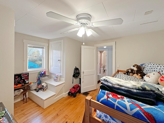 bedroom with ceiling fan and wood-type flooring