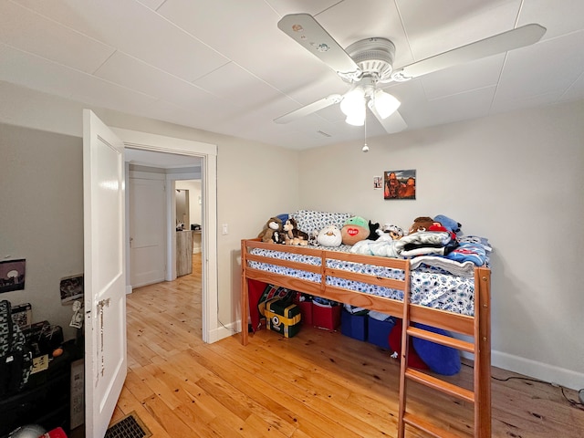 bedroom featuring hardwood / wood-style floors and ceiling fan