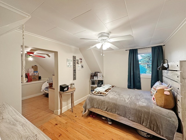 bedroom with ceiling fan, hardwood / wood-style flooring, and ornamental molding