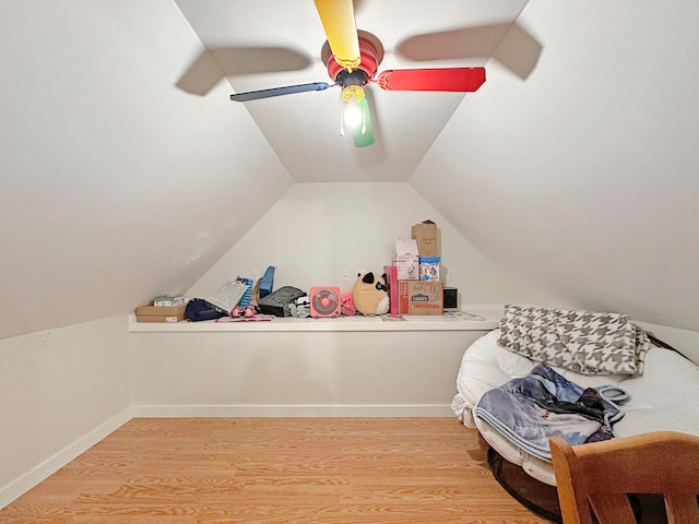 interior space with ceiling fan, vaulted ceiling, and light wood-type flooring