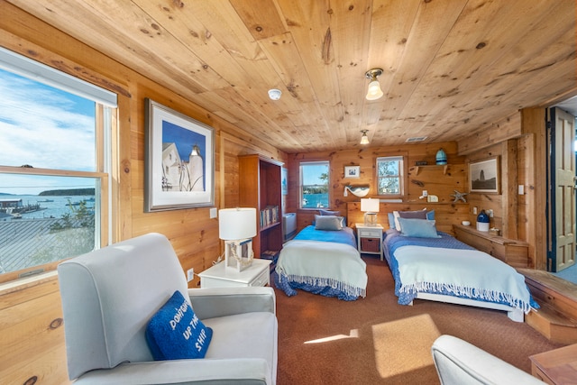 carpeted bedroom with wooden walls and wood ceiling