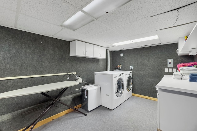 laundry room with cabinets, washer and dryer, and light colored carpet