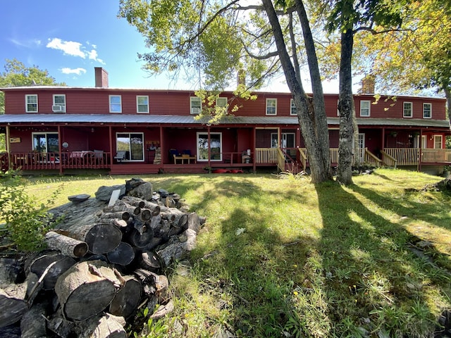 rear view of property with a yard and a chimney