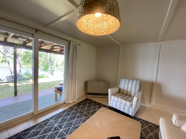 living area featuring tile patterned flooring and a decorative wall