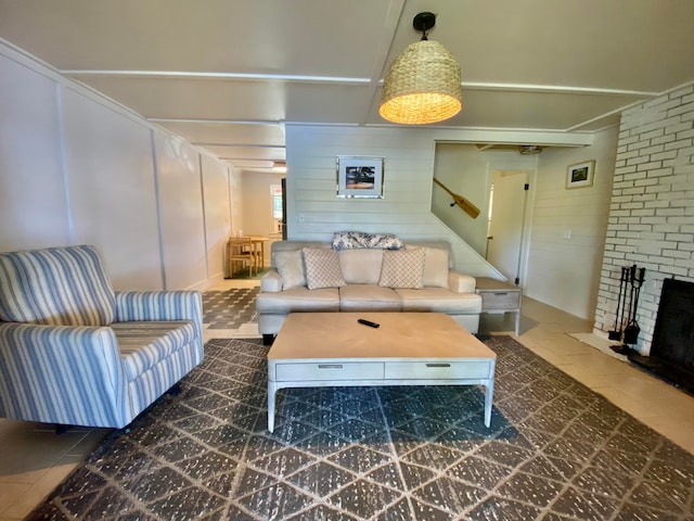 tiled living room with brick wall and a fireplace