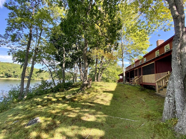 view of yard featuring a deck with water view
