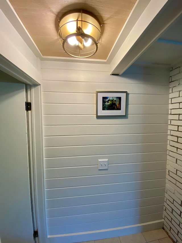 room details featuring wood walls and tile patterned flooring