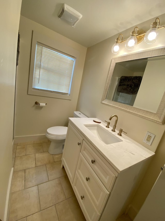 bathroom featuring tile patterned floors, toilet, baseboards, and vanity