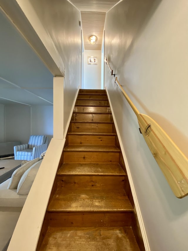 stairway with baseboards and hardwood / wood-style flooring