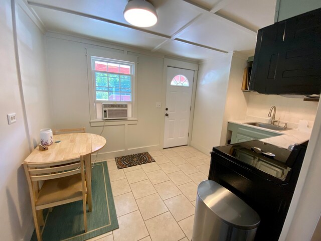 kitchen featuring light tile patterned floors, cooling unit, sink, and green cabinetry