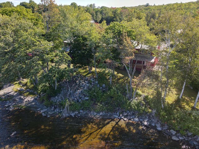 drone / aerial view with a wooded view