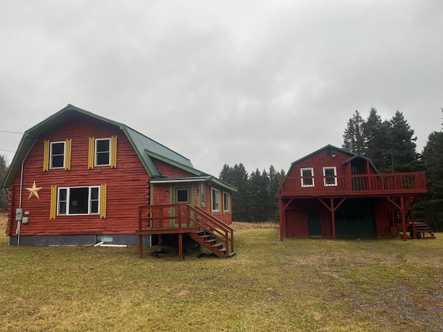 rear view of house featuring a deck and a lawn