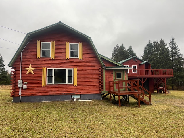 back of house featuring a yard and a wooden deck