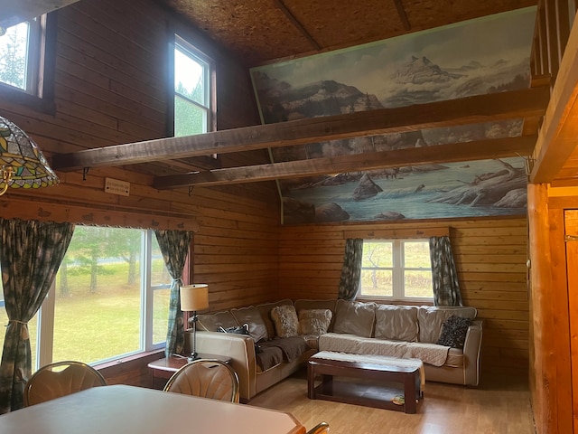 living room featuring wood walls, a wealth of natural light, and hardwood / wood-style floors