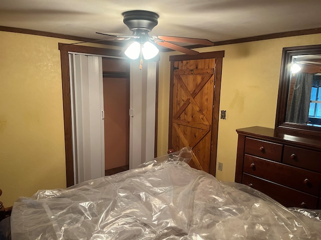 bedroom with ceiling fan and ornamental molding