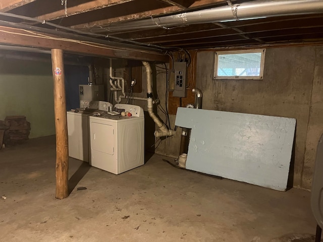 basement with independent washer and dryer, electric panel, and gas water heater