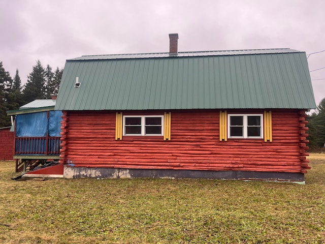 view of side of home featuring a lawn