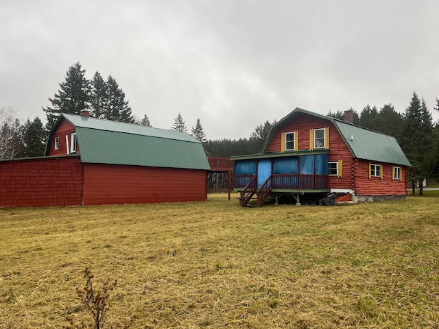 back of property with an outdoor structure and a lawn