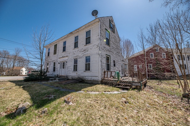 view of home's exterior featuring a wooden deck and a yard