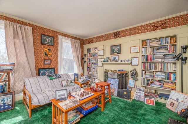 living area with crown molding and carpet flooring