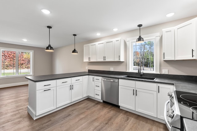 kitchen featuring stainless steel appliances, decorative light fixtures, and white cabinets