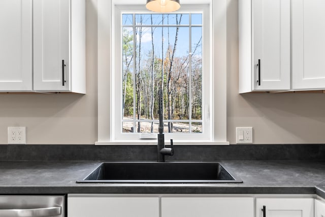 kitchen featuring white cabinets, sink, and a wealth of natural light