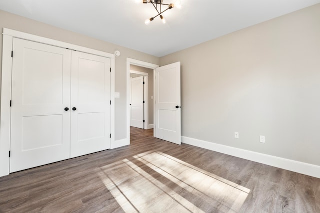 unfurnished bedroom with a closet and wood-type flooring