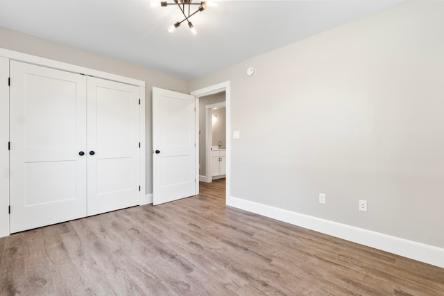 unfurnished bedroom with a closet and light hardwood / wood-style flooring