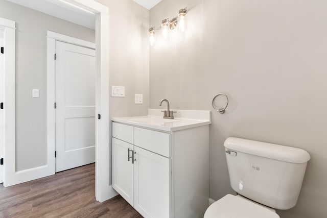 bathroom featuring vanity, toilet, and wood-type flooring